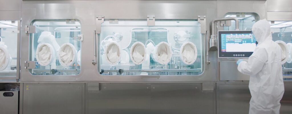 Operator using AST isolator for aseptic manufacturing 