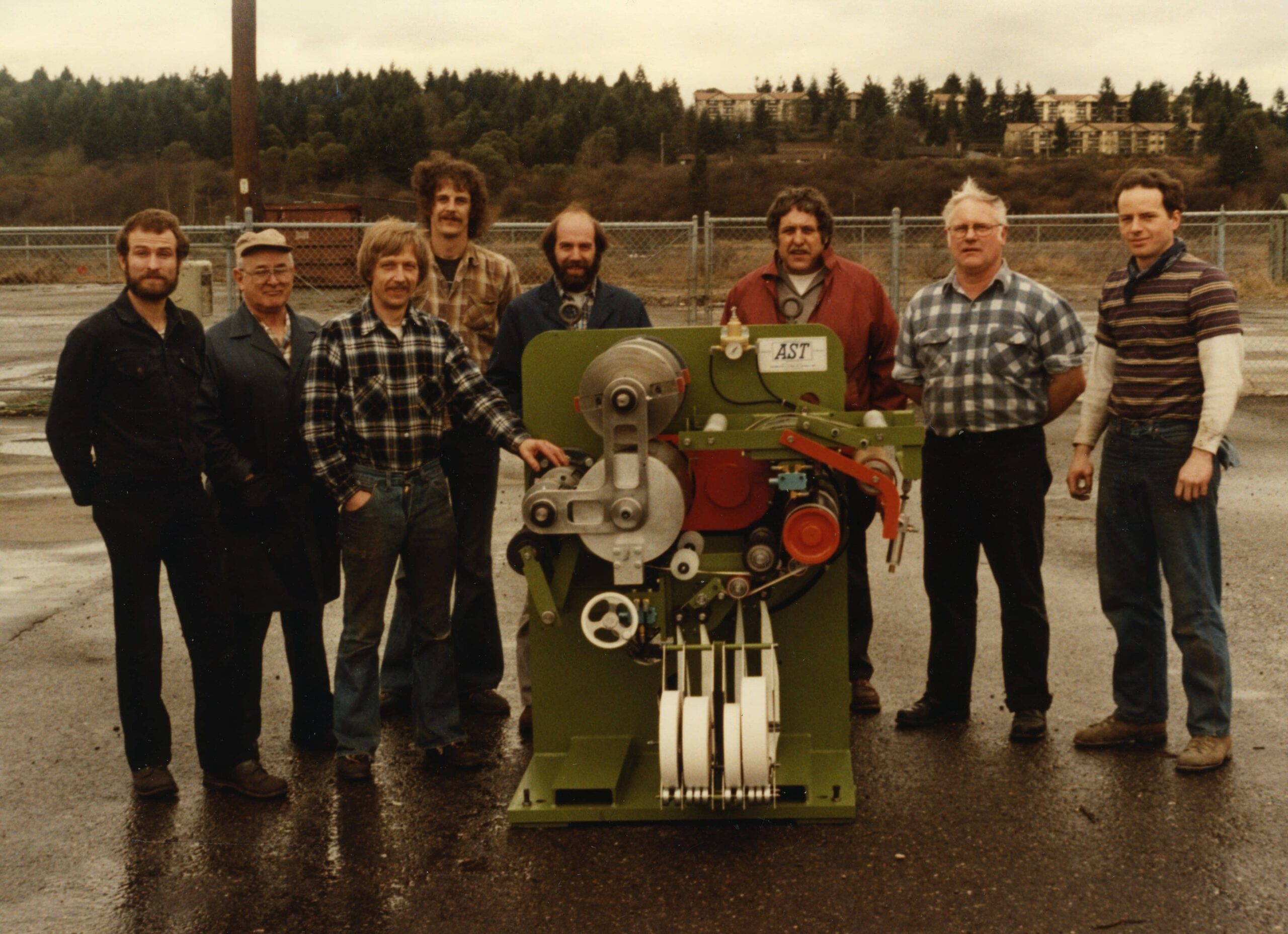 AST Team w/ a first-generation pinch cut taper machine, 1982