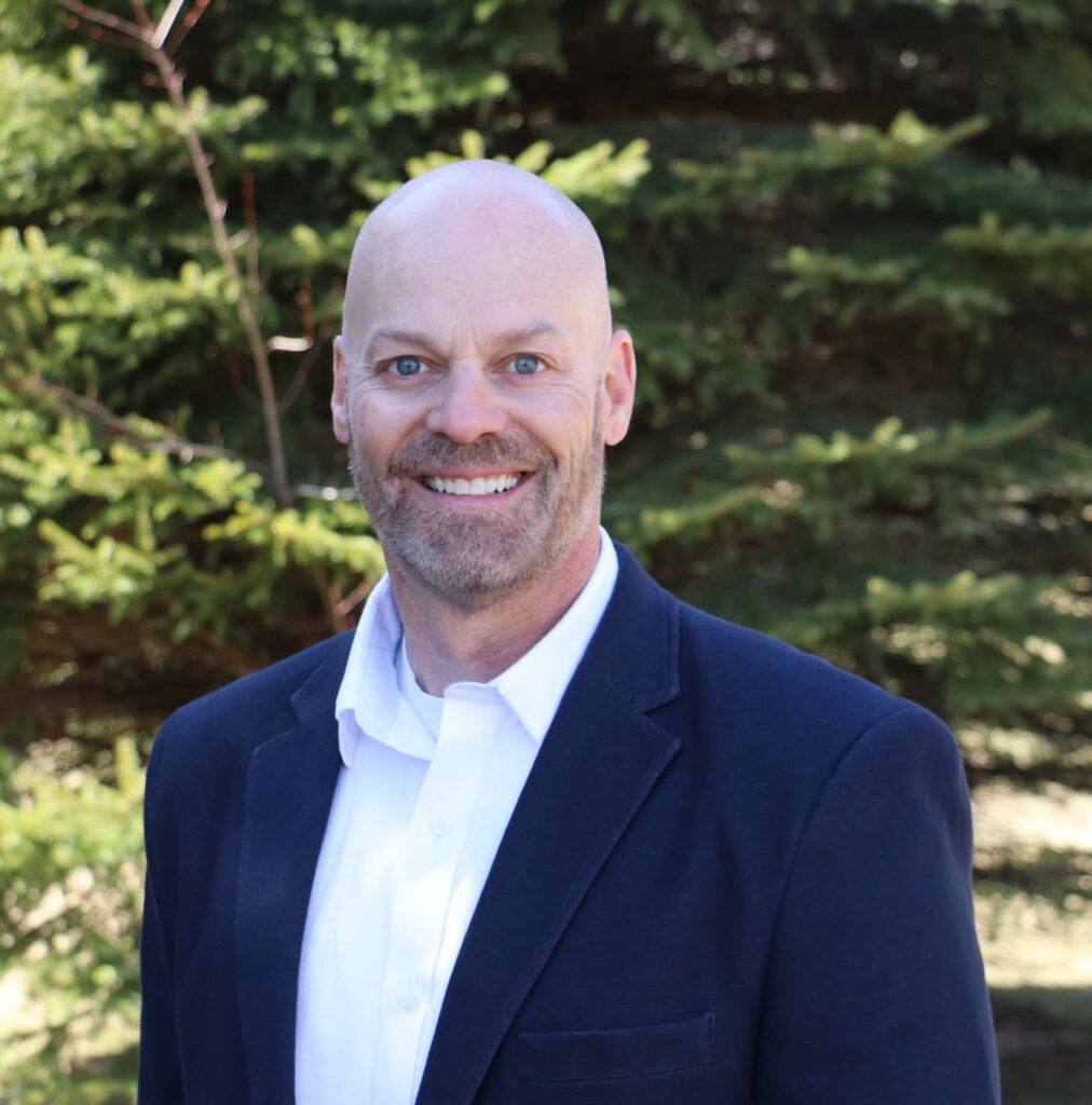 Jason Rossi headshot in front of AST headquarters in Tacoma Washington